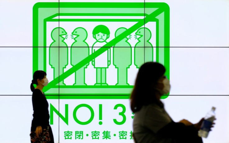 Signs promote social distancing in Tokyo's Shinjuku district as the country battles another uptick in Covid-19 infections