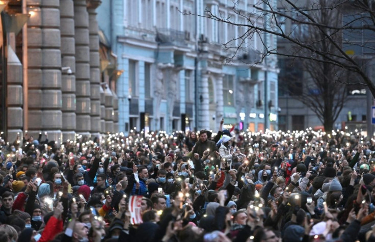 Opposition supporters hold their cell phones during a rally in support of jailed Kremlin critic Alexei Navalny in central Moscow