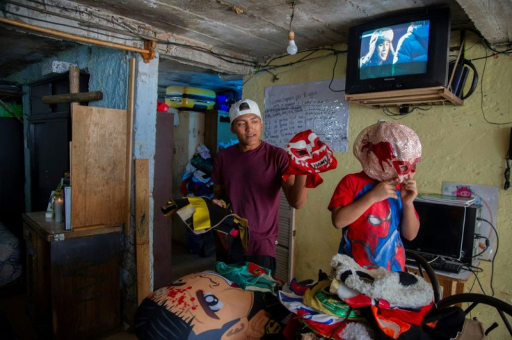 Mexican wrestler Lunatik Extreme shows some keepsakes of his father and fellow wrestler Ovett who died of Covid-19