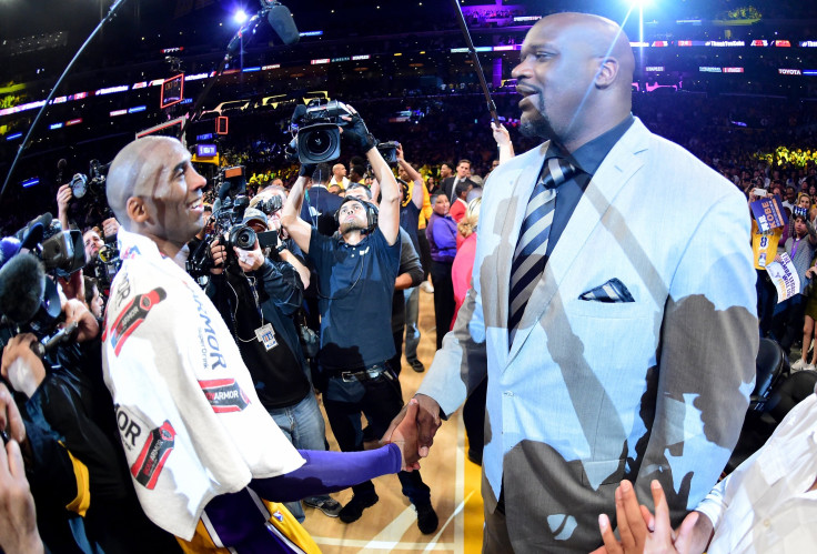Kobe Bryant #24 of the Los Angeles Lakers talks with former teammate Shaquille O'Neal after scoring 60 points in his final NBA game at Staples Center on April 13, 2016 in Los Angeles, California.