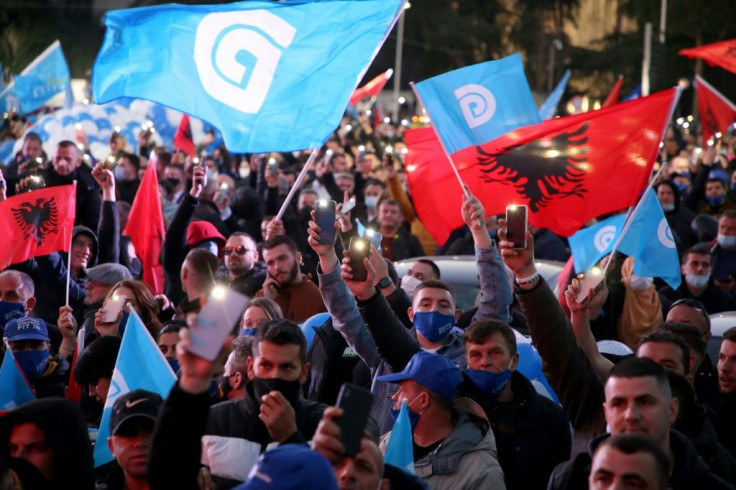 Albanian opposition Democratic Party supporters wave national and party flags during a rally last month