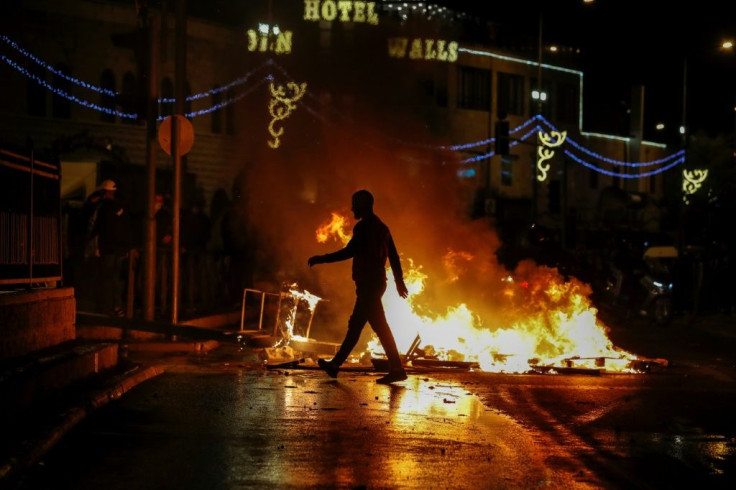 Palestinian protesters set rubbish ablaze on the streets of annexed east Jerusalem amid clashes with Israeli police in which more than 120 people are wounded