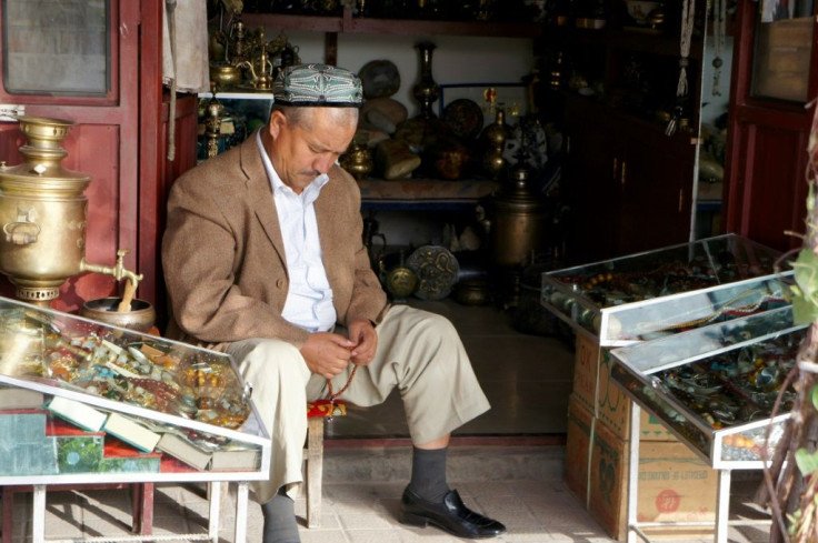 Rights groups say up to one million Uyghur Muslims, such as this man holding prayer beads in a shop in Kashgar, are detained in Chinese internment camps