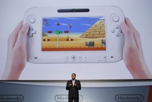 Fils-Aim, president of Nintendo of America, presents the new Wii U controller at a media briefing during the Electronic Entertainment Expo, or E3, in Los Angeles