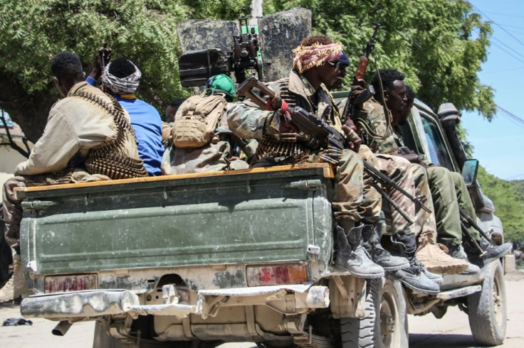 Fighters in a military force supporting Somali opposition leaders patrol a street in Mogadishu on Sunday