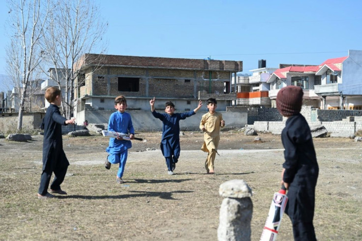Children play cricket at the site Osama bin Laden's demolished former compound
