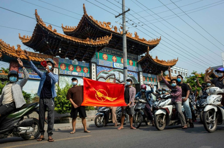 Protesters make the three-finger salute of resistance during a demonstration against the junta in Mandalay