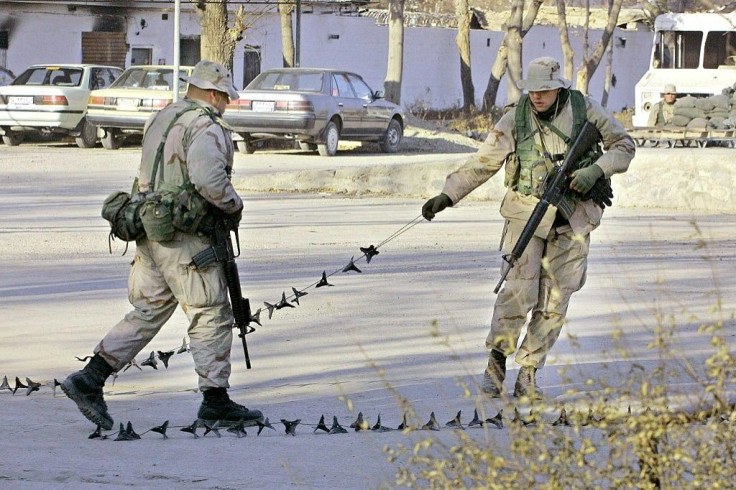 US Marines place a chain at the entrance of the US embassy in Kabul shortly after the fall of the Taliban in December 2001