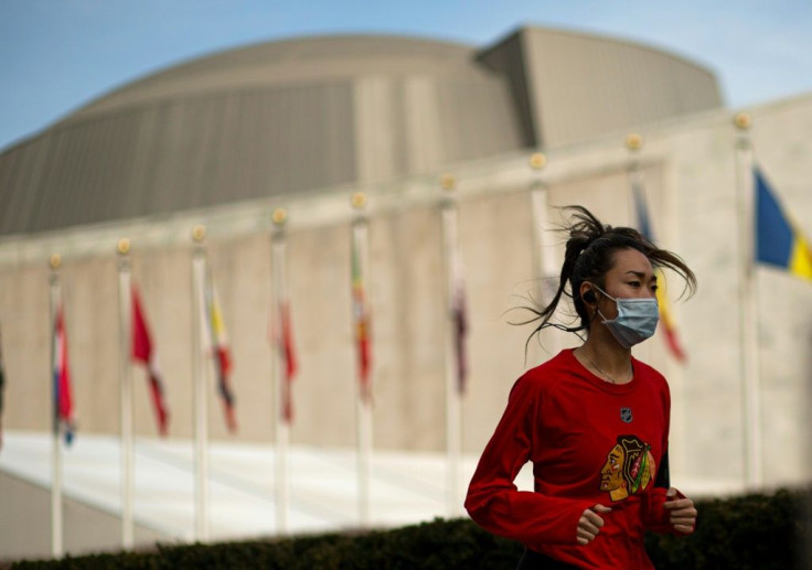 Under new guidelines, Americans like this jogger won't need to wear a mask doing many outdoors activities