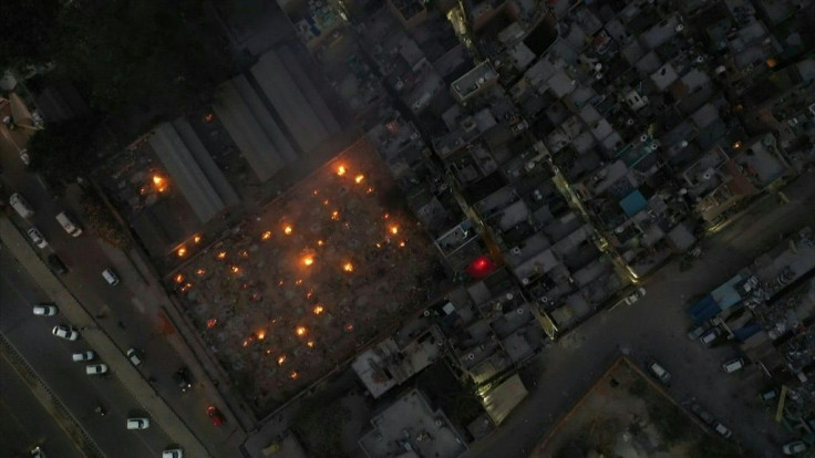 Smoke billows from dozens of pyres lit inside a parking lot that has been turned into a makeshift crematorium, after Indiaâs capital was gripped by a deadly wave of the pandemic that has deluged its hospitals and crematoriums equally. Loved ones filled 