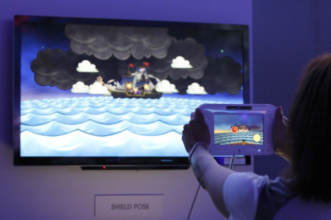 An assistant demonstrates the use of the new Nintendo Wii U controller during the Electronic Entertainment Expo, or E3, in Los Angeles 08/06/2011