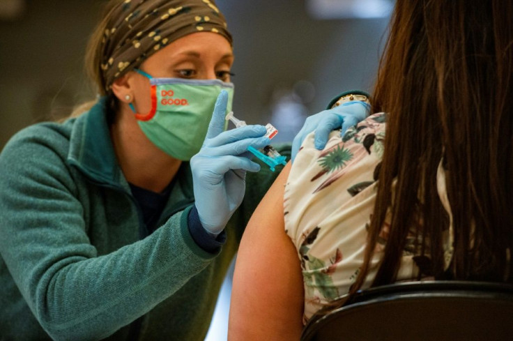 A medical worker administers the Johnson and Johnson Covid-19 vaccine to the public at a FEMA-run mobile Covid-19 vaccination clinic at Biddeford High School in Bidderford, Maine on April 26, 2021