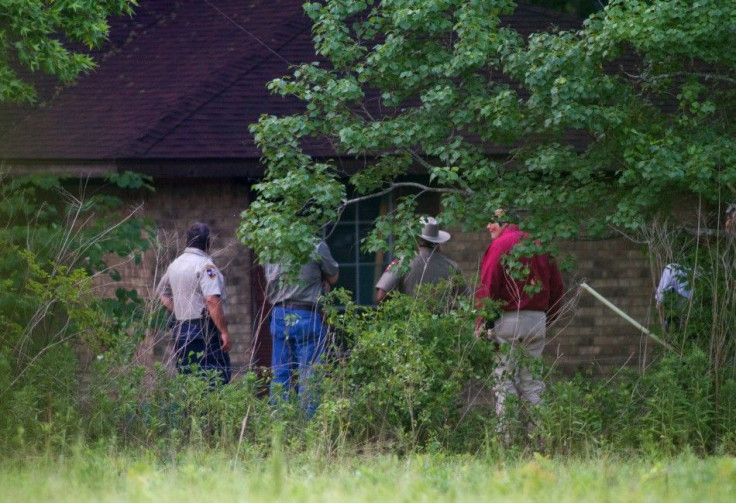 aw enforcement officers investigate a rural home after a psychic called the Liberty County, Texas Sheriff&#039;s Office