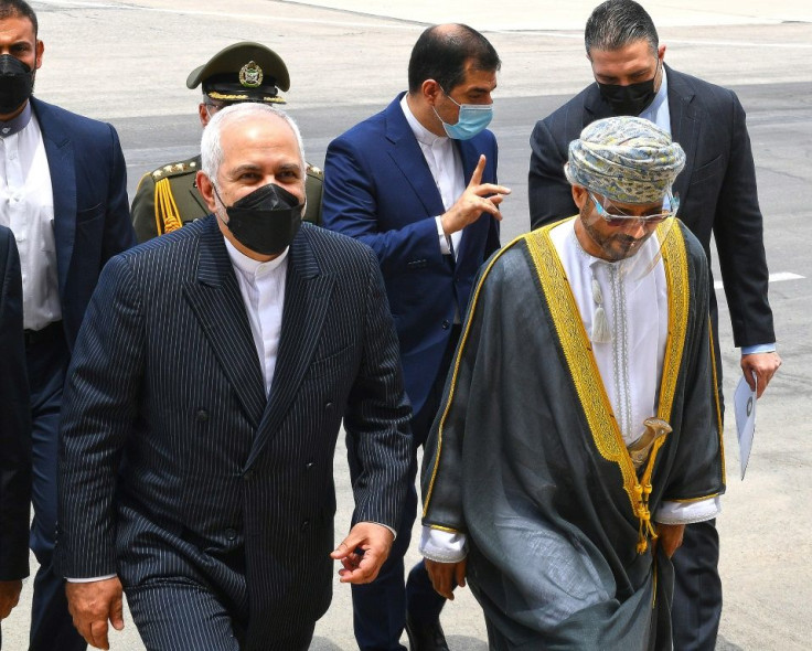 Iranian Foreign Minister Mohammad Javad Zarif (L) arrives in the Omani capital Muscat on April 28, 2021 as part of a regional tour