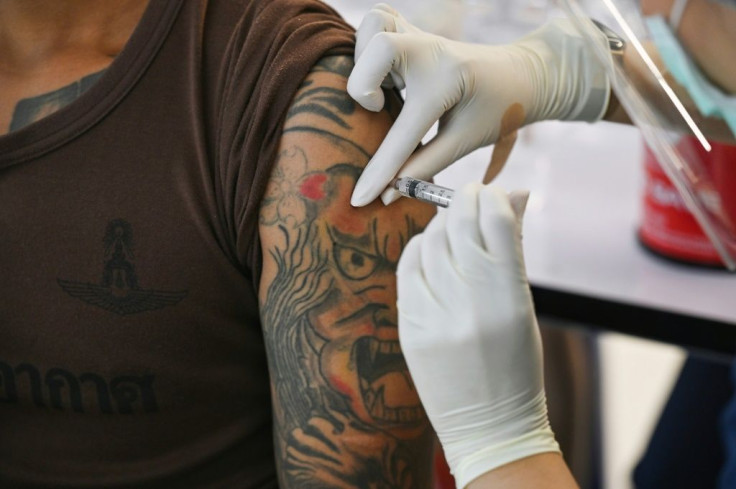 An airport staff member is vaccinated in Bangkok