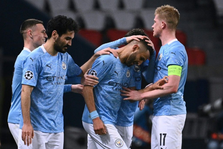 Manchester City players congratulate Riyad Mahrez after his free-kick gave the English side a 2-1 win in Paris