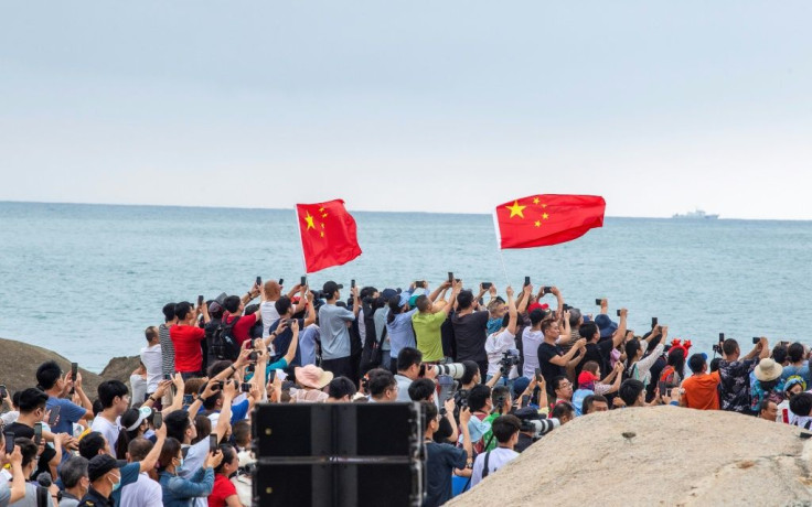 A band played music as onlookers snapped photos during the launch -- a milestone in Beijing's plans to establish a permanent human presence in space