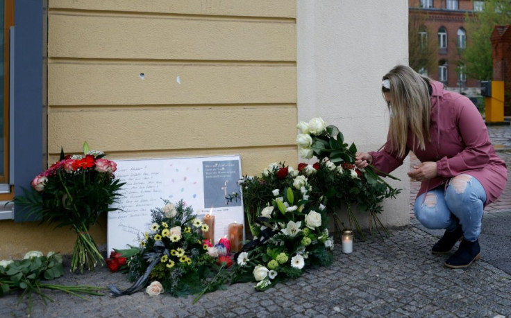 Flowers and candles have been placed outside the Oberlin care clinic in the German city of Potsdam after the killings