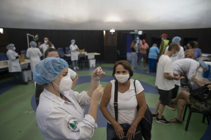 People receive coronavirus vaccines at the Public Planetarium in Rio de Janeiro, in March 2021