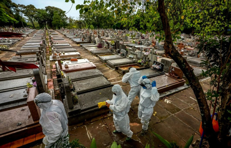 Workers prepare for the burial of a Covid-19 victim at the Sao Joao municipal cemetery in Porto Alegre, Brazil in March 2021