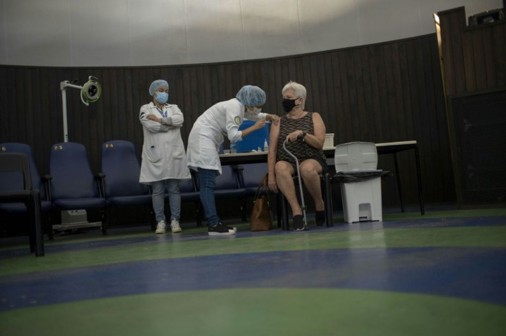 A woman is vaccinated against the coronavirus at Rio de Janeiro's Public Planetarium in March 2021
