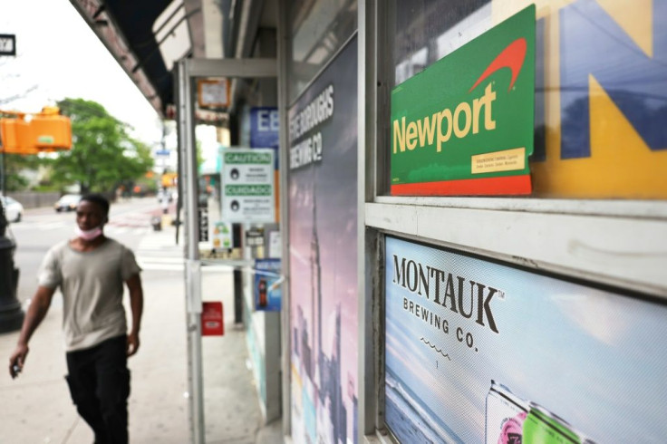 A Newport cigarettes sticker is seen on a window outside of a grocery store in New York City