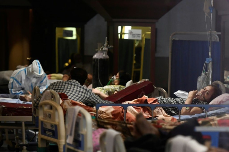 Patients rest inside a banquet hall used as a makeshift coronavirus ward in New Delhi