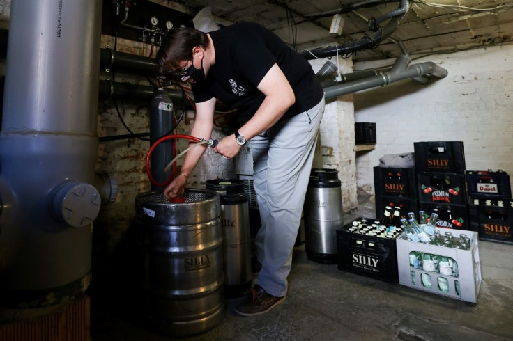 Sebastien Weverbergh, manager of the Café de la Brasserie, prepares his bar for reopening