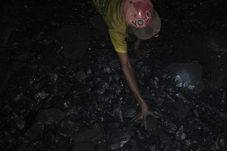 Miners manually hew coal and drag it up to the surface, where it sells for just $35 per tonne