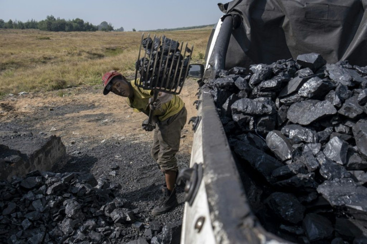 Pickup trucks are used to transport the hand-mined coal away from the shaft