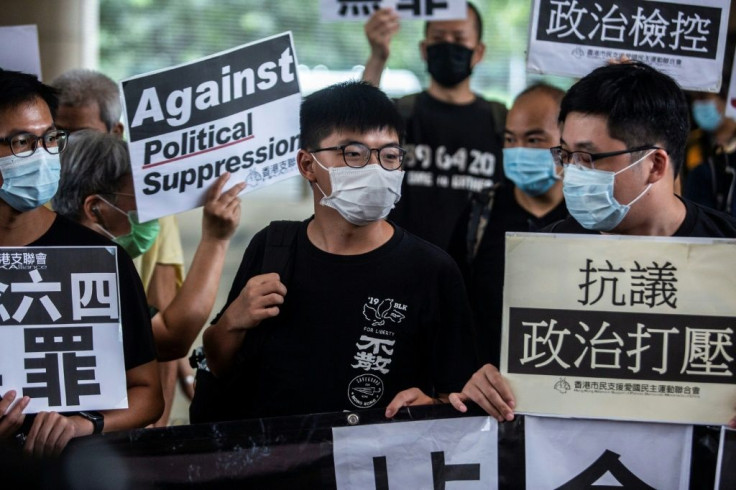 Pro-democracy activist Joshua Wong (C) is currently serving a jail sentence for taking part in a protest during the months of huge and often violent democracy rallies that rocked Hong Kong in 2019