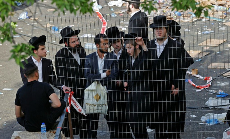 Orthodox Jewish men gather in the northern Israeli town of Meron at the scene of a night-time stampede