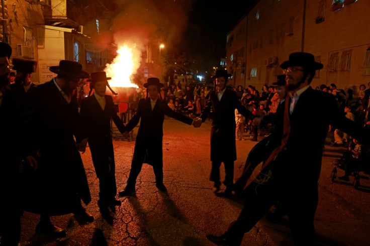 Ultra-Orthodox Jews gather around a bonfire in an ultra-Orthodox neighbourhood in JerusalemÂ on April 29,Â 2021, to celebrate the Jewish holiday of Lag BaOmer