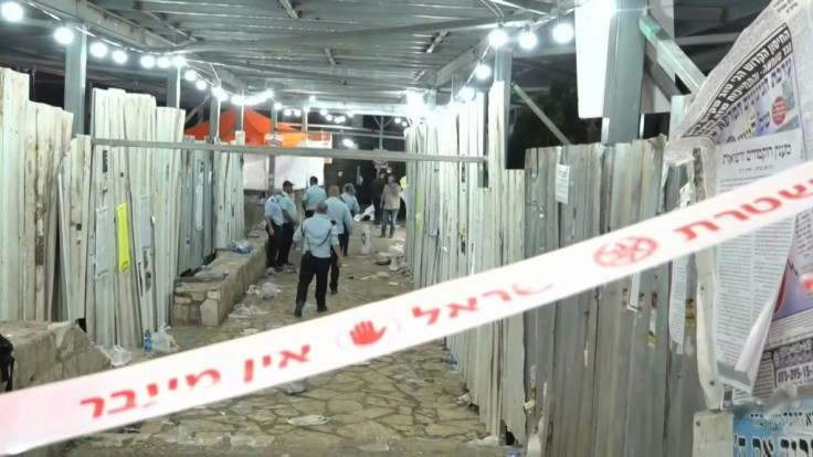 IMAGESIsraeli police cordon off the site of a stampede at a Jewish pilgrimage site that killed at least 44 people, as shocked pilgrims gather nearby in mourning.
