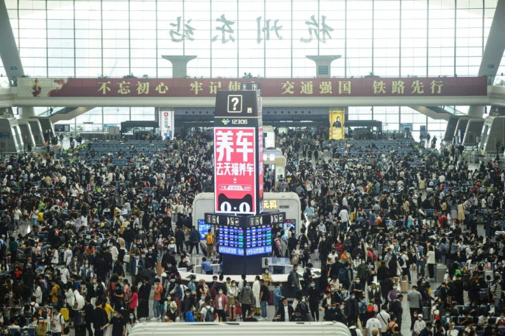Passengers prepare to board trains at Hangzhou East train station in Hangzhou, in China's eastern Zhejiang province on April 30, 2021, ahead of the Labour Day holiday