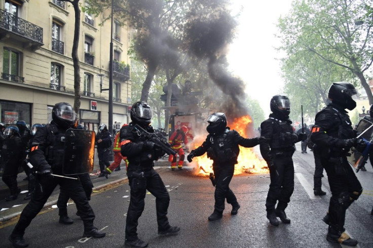 Some protesters in Paris smashed bank branch windows and set fire to dustbins