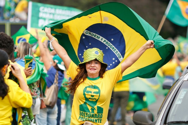 A demonstrator holds a Brazilian flag during a protest in Brasilia in support of President Jair Bolsonaro, on May 1, 2021