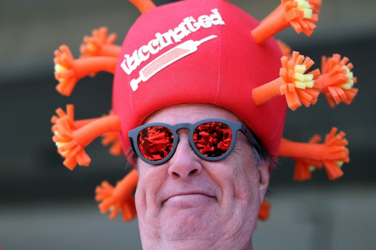 Spectator Mark Ferguson of Texas offers a reminder of the Covid-19 pandemic as the 147th Kentucky Derby welcomed more than 51,000 fans to Churchill Downs in Louisville, Kentucky