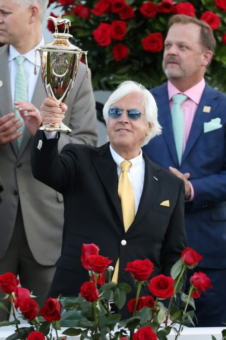 Trainer Bob Baffert hoists the Kentucky Derby trophy after Medina Spirit's victory in the 147th edition gave him a record seventh triumph in the Triple Crown race
