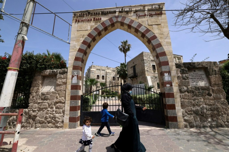 People walk past Qasr al-Basha, where Napoleon Bonaparte reportedly stayed, in Gaza City on April 21, 2021