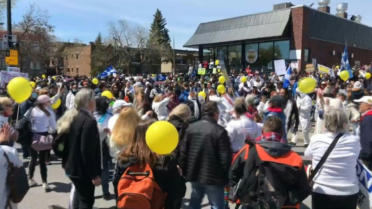 IMAGESDemonstrators gather in Montreal to protest masks, an 8pm curfew in Quebec province and other sanitary measures. Some of the protesters are also anti-vaccine.