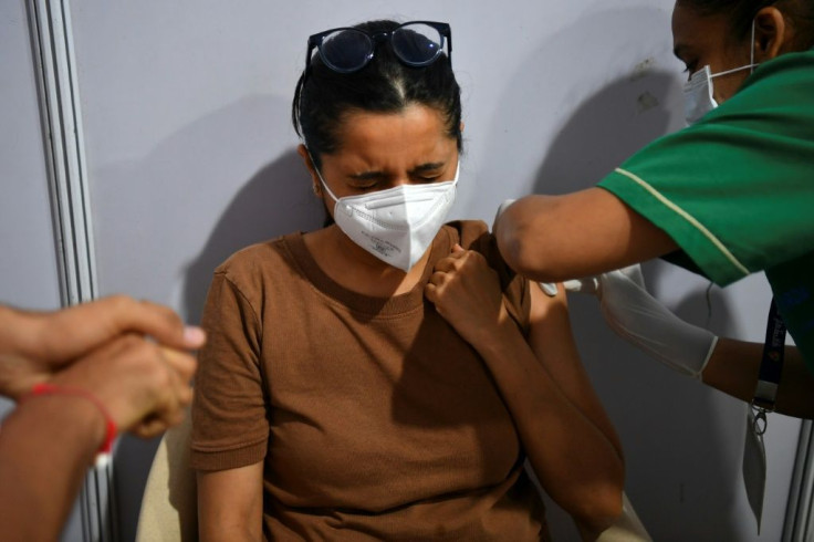 A woman is vaccinated in Mumbai