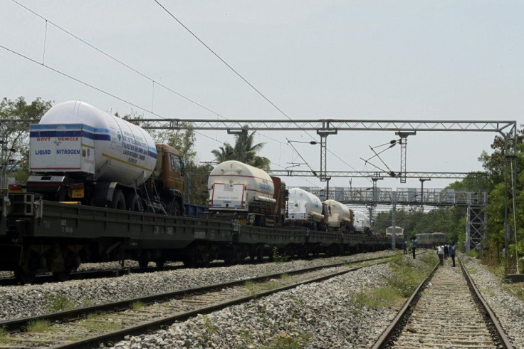 Oxygen tankers are carried into the Indian city of Hyderabad by train