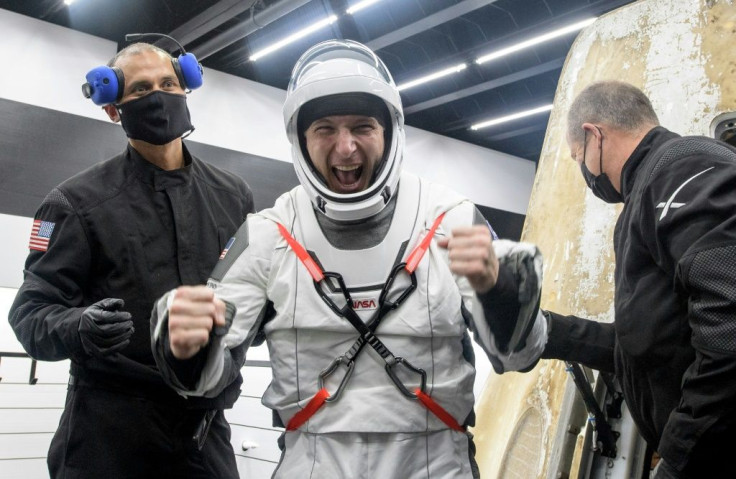 NASA astronaut Michael Hopkins was the first to emerge from the capsule after the hatch was opened aboard the recovery ship