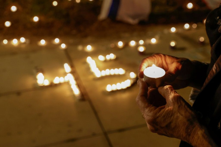 People light candles during a vigil in Habima Square in the Israeli coastal city of Tel Aviv