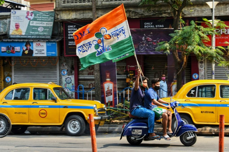 Supporters celebrate the TMC's lead in the West Bengal state elections
