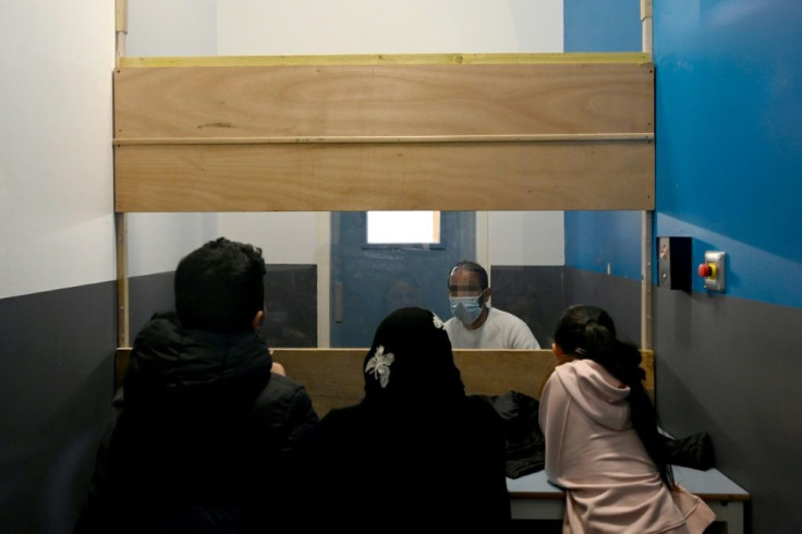 Separated by a window, children visit their father at a Marseille prison for 45 minutes