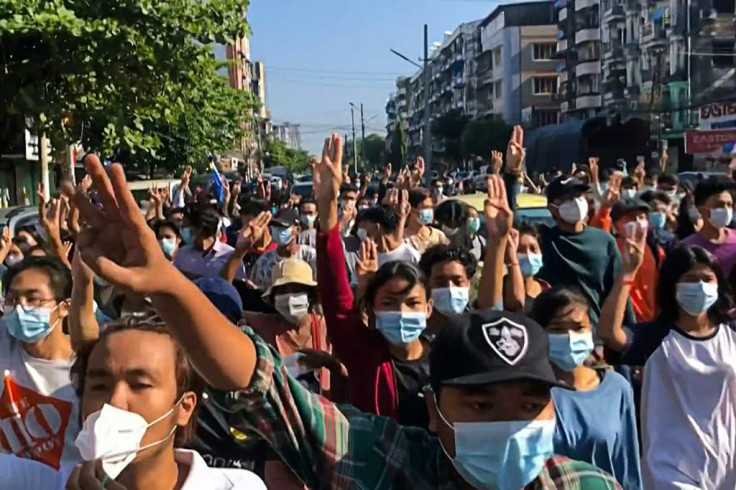 Protesters make a three-finger salute as they take part in a flash mob as part of demonstrations against the military coup in Yangon