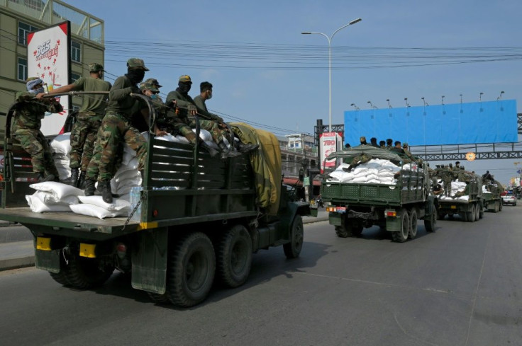 Soldiers have been transporting sacks of rice to people in red zones in Phnom Penh