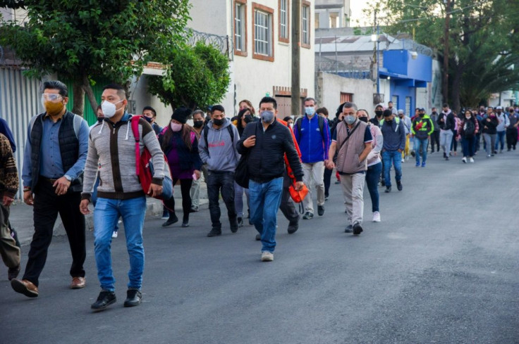 Commuters walk in search of alternative transportation after the deadly accident